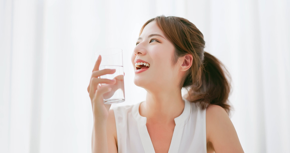 Woman enjoying clean OSMO purified water